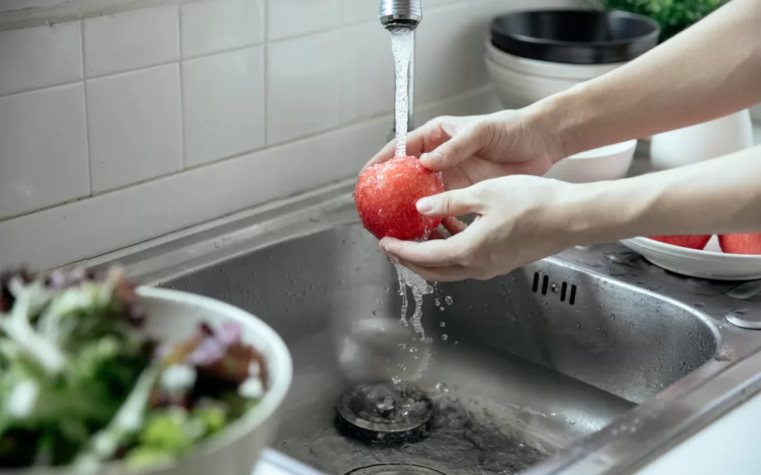 Rinsing an apple with tap water