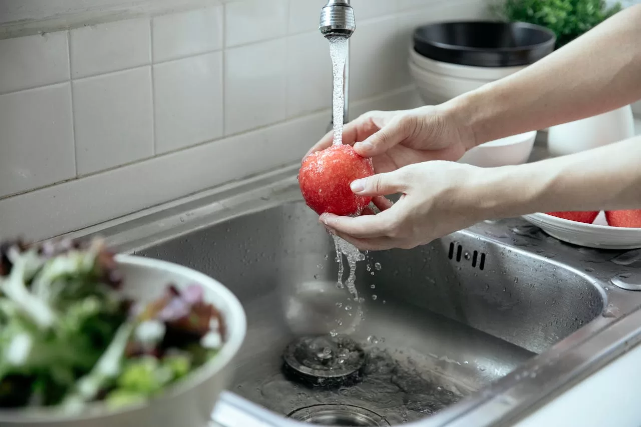 Rinsing an apple with tap water