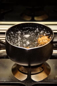 Water boiling at a full, rolling boil on a kitchen stove