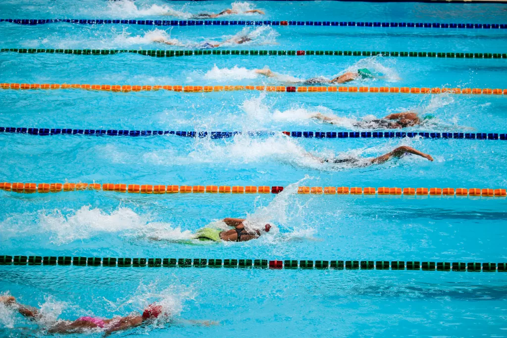 Swimmers in a pool with chlorine-treated water